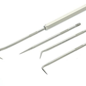 May include: A set of four silver-colored metal tools with various hook and pointed ends. The tools have textured handles and are designed for precision work. The set includes a long handle and three smaller tools.