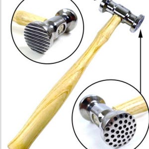 May include: A silver metal hammer with a wooden handle. The hammer has two different heads, one with a textured surface and one with a smooth surface.