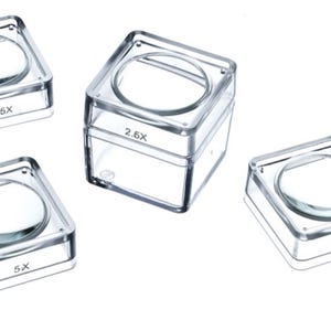 May include: Four clear plastic magnifying boxes with different magnifications: 2.6x, 3.6x, 4x, and 5x.