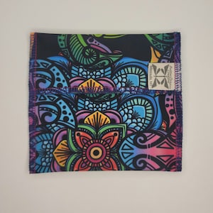 May include: A colorful mandala pattern fabric pouch with a black background. The pouch has a purple seam and a small white label with the text "Better Design Co. Missoula, MT".