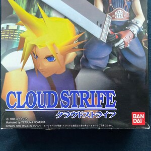 May include: Box art for the video game Cloud Strife, featuring a character with spiky yellow hair and a large sword. The title "CLOUD STRIFE" is prominently displayed in white and blue. The Bandai logo is visible.