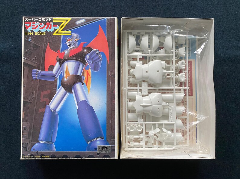 May include: A white ceramic mug with a black handle and the text "But First, Coffee" in a handwritten style. The mug is on a white surface. The mug is 4 inches tall.