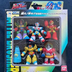 Puede incluir: Un conjunto de seis figuras de acción de plástico de la serie de videojuegos Mega Man. Las figuras están empaquetadas en una caja de plástico transparente con un respaldo de cartón colorido. Las figuras incluyen Mega Man, Proto Man y cuatro maestros robots. La caja presenta el texto "Battle Brusher" y "闘え!倒せ!!新格闘アクション・フラッシュシステム!"