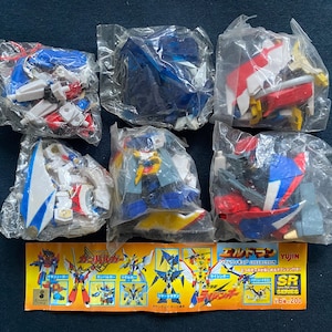 May include: A set of six plastic model kits in individual clear plastic bags. The kits are for building a robot with blue, red, white, and yellow parts. The bags are arranged in two rows of three. The image also includes a card with the text "Super Robot Collection SR Series 75x200 Yuujin" in Japanese and English.