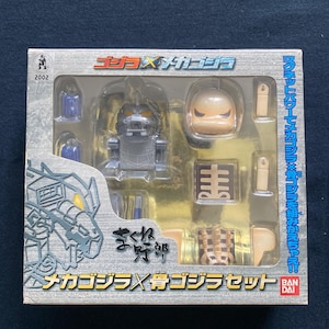 May include: A boxed Godzilla x Mechagodzilla toy set. The packaging features Japanese text and illustrations of the characters. The set includes various toy parts and accessories, with a clear plastic window showcasing the contents.