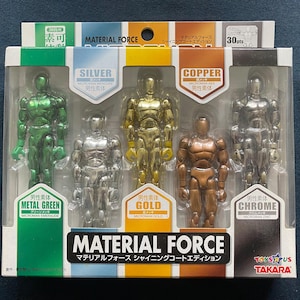 May include: A boxed set of five metallic action figures in green, silver, gold, copper, and chrome. The packaging reads "MATERIAL FORCE" and "SHINING COAT EDITION". Each figure is labeled with its color and material.