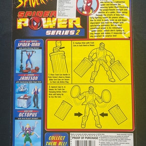 May include: Spider-Man action figure from the Spider-Power Series 2. The figure is red and blue with a black spider symbol on the chest. The figure is holding two trash cans in its hands. The figure is posed in a dynamic action pose. The packaging also features images of other Spider-Man characters, including Doctor Octopus and J. Jonah Jameson.