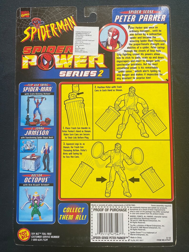 May include: Spider-Man action figure from the Spider-Power Series 2. The figure is red and blue with a black spider symbol on the chest. The figure is holding two trash cans in its hands. The figure is posed in a dynamic action pose. The packaging also features images of other Spider-Man characters, including Doctor Octopus and J. Jonah Jameson.