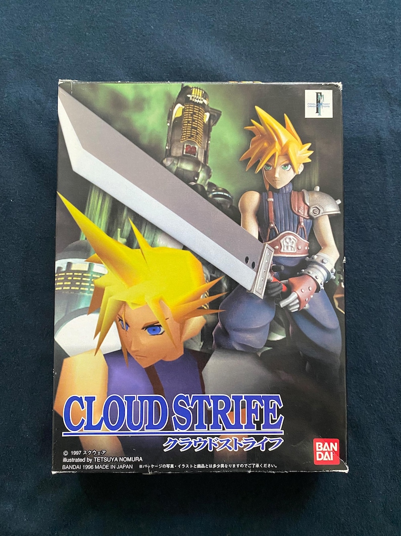 May include: A box featuring Cloud Strife from Final Fantasy VII. The artwork shows Cloud with spiky yellow hair and a large silver sword. The title "CLOUD STRIFE" is displayed, alongside Japanese text and the Bandai logo. The box is dark with a blue background.
