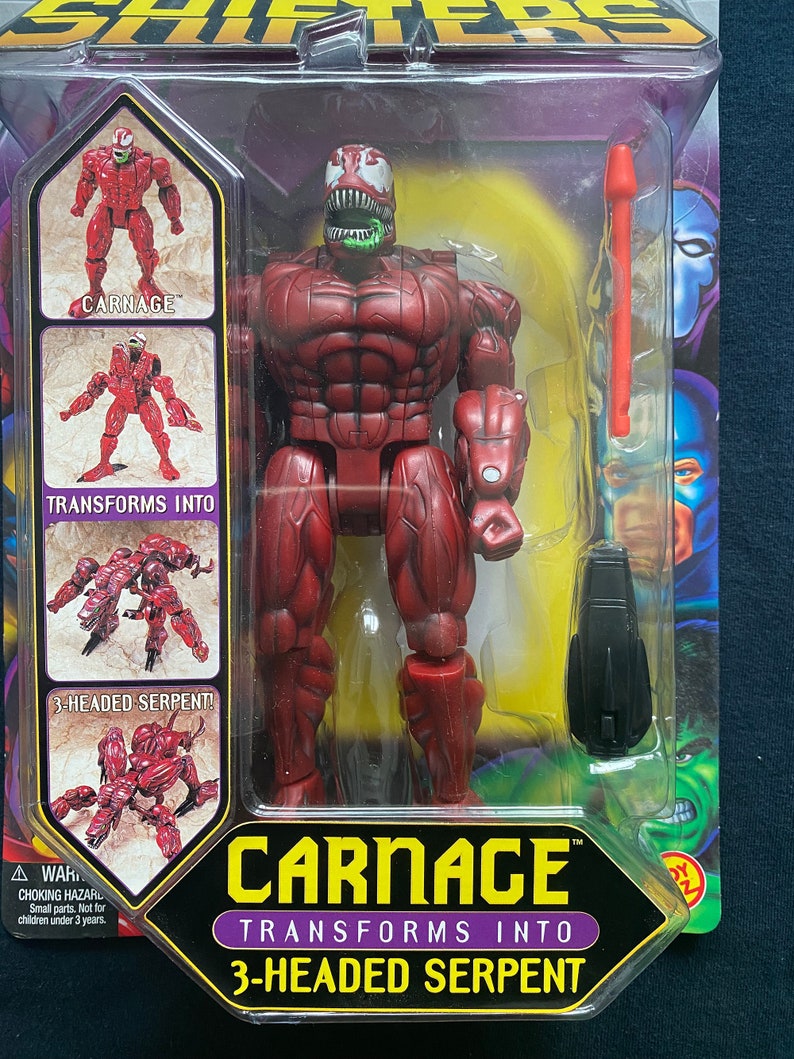 May include: Carnage action figure from the Marvel Legends line. The figure is red and black and transforms into a three-headed serpent. The packaging includes the figure, a weapon, and a card with the figure's name and transformation instructions.
