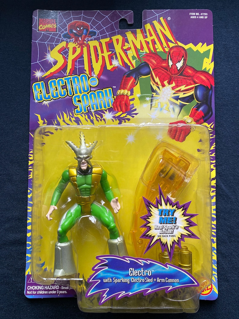 May include: Action figure of Electro from the Spider-Man Electro Spark series. The figure is green and silver with a yellow lightning bolt design. The figure comes with a sparking electro sled and arm cannon. The packaging features a yellow background with a red and blue Spider-Man character.