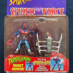 May include: Spider-Man action figure with transforming insect armor. The figure is red and blue with a silver spider symbol on the chest. The figure comes with a silver and black weapon and a separate insect armor piece. The packaging features the text "Spider-Man Spider Force" and "You Turn Spider-Man Into A Powerful CyberSpider!"