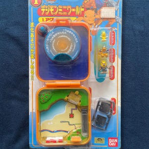 May include: Sealed Digimon Mini World toy set. The packaging is blue and orange, with Japanese text and character illustrations. The set includes a small, detailed world map and miniature figures.