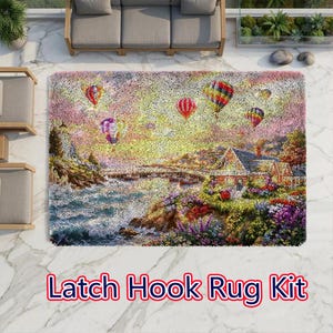May include: A rectangular latch hook rug kit featuring a coastal landscape with a house, colorful flowers, and hot air balloons in a sunset sky. The scene includes a rocky shoreline, a calm sea, and vibrant multi-colored balloons floating above.