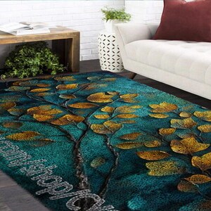May include: Teal and gold area rug with a leafy pattern. The rug has a soft, plush texture and is perfect for adding a touch of elegance to any room.