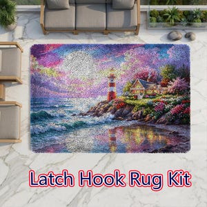 May include: A rectangular latch hook rug kit featuring a coastal scene with a lighthouse, a house, and a rocky shoreline. The image displays a vibrant sunset sky in shades of purple and pink, with the lighthouse and house reflected in the water.