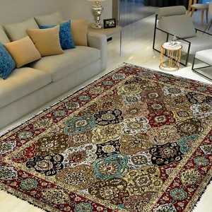 May include: A colourful, intricate patterned rug with a red, gold, and blue colour scheme. The rug has a traditional Persian design with floral and geometric motifs.