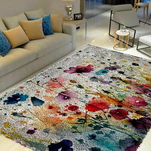 Könnte beinhalten: Ein weißer Teppich mit einem farbenfrohen Blumendesign. Der Teppich zeigt eine Vielzahl von Blumen in den Farben Rosa, Rot, Gelb, Blau und Grün. Die Blumen sind in Aquarelltechnik gemalt, was dem Teppich ein weiches und verspieltes Aussehen verleiht.