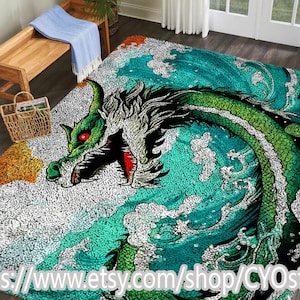 May include: A large area rug featuring a detailed illustration of a green dragon with red eyes against a backdrop of teal waves and white foam. The dragon's head is prominently displayed, with its mouth open. The rug has a textured appearance.