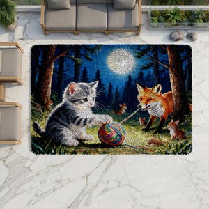 May include: A rectangular area rug featuring a detailed scene of a gray tabby kitten playing with a multicolored yarn ball alongside a red fox and two small fox kits in a forest at night under a bright full moon, with dark trees in the background.