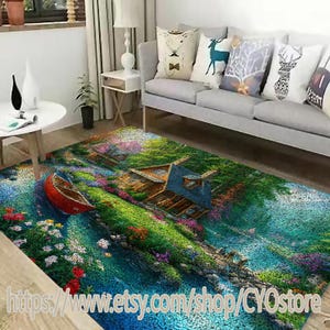 May include: A colorful area rug with a blue river, green grass, a small cottage, and a red boat. The rug has a pebble-like texture.