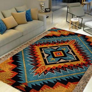 May include: A colourful rug with a geometric pattern in shades of blue, orange, yellow, and black. The rug has a fringed edge and is laid out on a light-coloured floor in a living room setting.