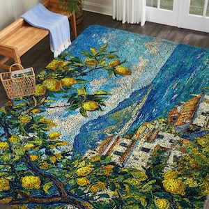 May include: A large area rug with a vibrant, impressionistic design. The rug features a coastal scene with lemon trees, buildings, and a blue sky. The color palette includes shades of blue, yellow, green, and white, creating a lively and artistic aesthetic.