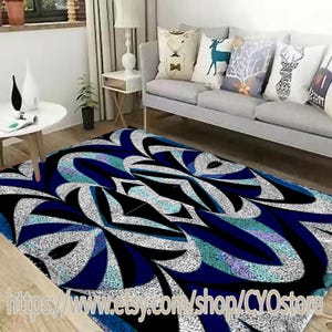 May include: Abstract area rug with a black, white, and blue geometric pattern. The rug has a modern design with a swirling pattern.
