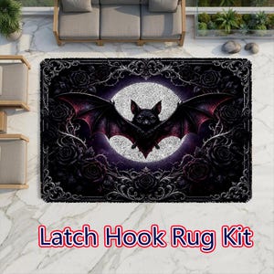 May include: A rectangular latch hook rug kit featuring a central black bat with spread wings centered against a large white moon. The design is surrounded by a dark border of black roses and ornate scrollwork. The text Latch Hook Rug Kit is visible.