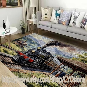 May include: A rectangular area rug featuring a detailed illustration of a vintage steam train on a track, with a backdrop of a mountainous landscape. The rug has a brown and green color scheme, with the text "https://www.etsy.com/shop/CYOstore" at the bottom.
