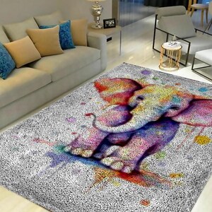 May include: A fluffy white rug with a colorful watercolor elephant design. The elephant is pink, purple, blue, and yellow. The rug is perfect for a living room or bedroom.