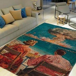 May include: A teal blue rug with a vintage illustration of three people sitting on a beach with a large mushroom cloud in the background. The rug has a textured, woven look.