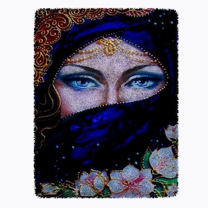 May include: A woman's face is partially obscured by a blue veil with gold embroidery. Her eyes are visible and are a bright blue. The veil is decorated with white flowers.