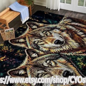 May include: A rectangular area rug featuring two detailed wolf faces. The wolves have brown, gold, and white fur, with piercing yellow eyes. The background is dark with colorful accents. The rug is designed to be placed on a floor.