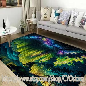 May include: A colorful area rug with a galaxy design featuring a dark blue background with a bright yellow, green, and purple galaxy. The rug is in a living room setting with a gray couch and pillows.