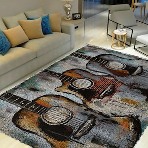 May include: A gray, blue, and brown area rug with a design of three acoustic guitars. The guitars are painted in a watercolor style with splashes of color.