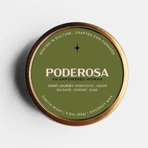 May include: A round candle tin with a metallic gold rim and a dark olive green label. The label features the text PODEROSA, AN EMPOWERED WOMAN, ROOTED IN CULTURE, CRAFTED CON CORAZON, and lists scent notes of rosewood, cedar, balsame, incense, and sage.