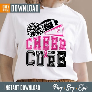 May include: White t-shirt with a black and pink design that says "Cheer for the Cure". The design includes a football, a cheerleader's pom-pom, and a megaphone.
