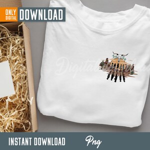 May include: A white t-shirt with a graphic design of a skull with horns, a sunset, and cacti. The text "That's the Truth" is above the skull. The graphic is in a vintage style with brown, orange, and green colors.