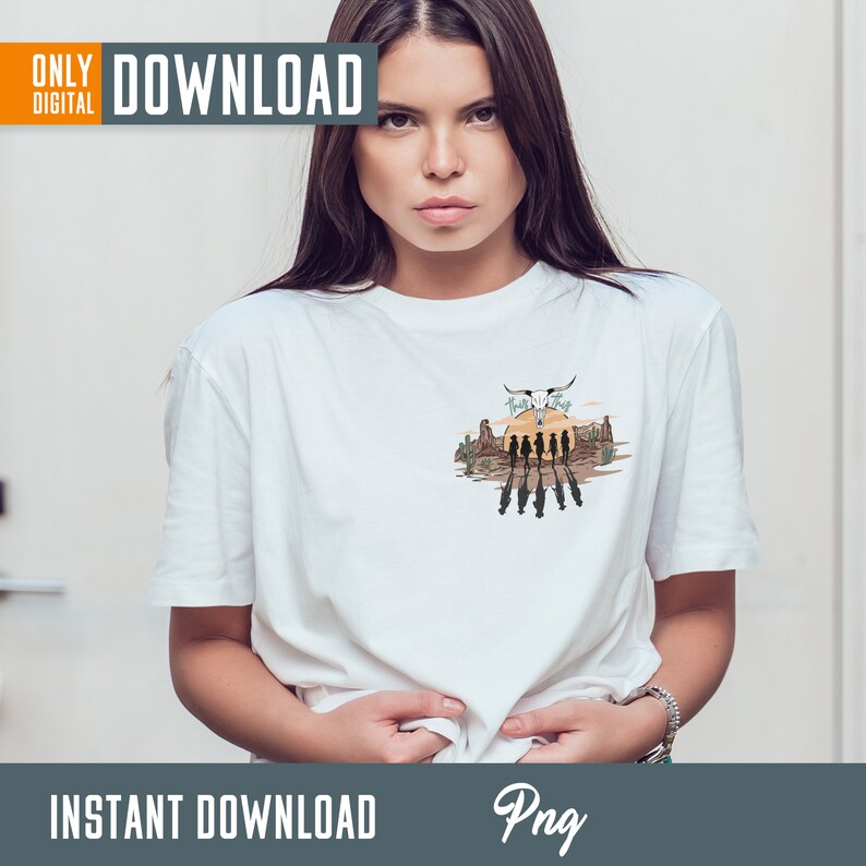 May include: A white t-shirt with a graphic design of a sunset scene with a skull and crossbones and the text "Hasta La Vista" in a western style font.