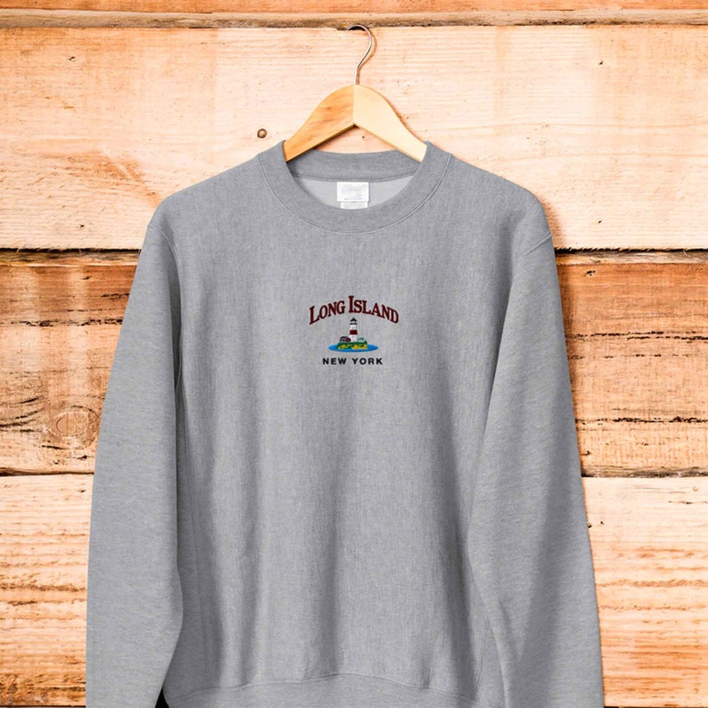 May include: Gray sweatshirt with a white embroidered lighthouse graphic and the text "Long Island New York".