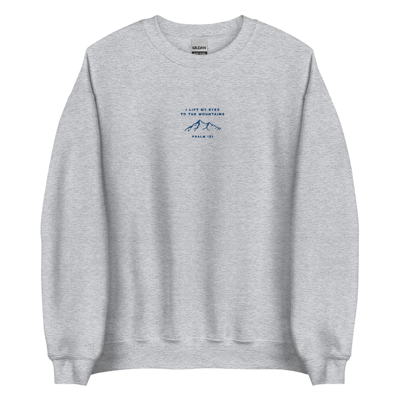 May include: A heather grey sweatshirt with a navy blue mountain graphic and the text "I lift my eyes to the mountains, Psalm 121".