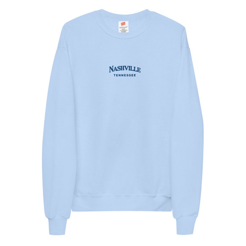 May include: A light blue sweatshirt with the text "NASHVILLE TENNESSEE" in navy blue.