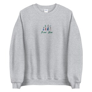May include: A gray sweatshirt with a green embroidered design of potted plants and the text "PLANT MOM".