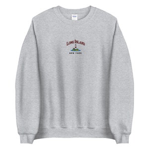 May include: Gray sweatshirt with a maroon embroidered design that says "Long Island, New York" with a lighthouse and island graphic.