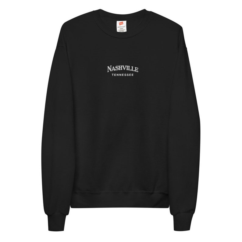 May include: Black long-sleeve sweatshirt with a white embroidered design that says "NASHVILLE TENNESSEE".