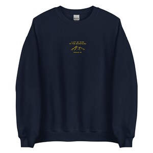 May include: Navy blue sweatshirt with a gold embroidered mountain design and the text "I lift my eyes to the mountains Psalm 121".
