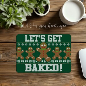 May include: Green mousepad with a white snowflake pattern and gingerbread men. The text "Let's Get Baked!" is printed in white.