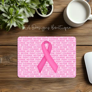 May include: Pink mouse pad with a pink ribbon in the center and the words "Fight Courage No Fear" repeated in a pattern.