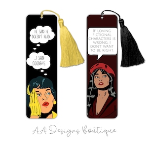 May include: Two rectangular bookmarks with pop art illustrations. The left bookmark is black with a yellow tassel and text reading HE SAID HE DOESN'T READ... I SAID GOODBYE. The right bookmark is dark red with a black tassel and text reading IF LOVING FICTIONAL CHARACTERS IS WRONG, I DON'T WANT TO BE RIGHT.